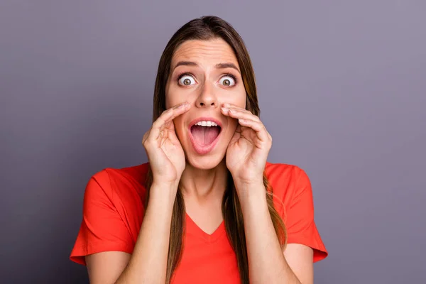 Photo of crazy terrified lady holding hands near mouth yelling sos frightened see street serial killer eyes full fear wear casual orange t-shirt isolated grey color background — Stock Photo, Image