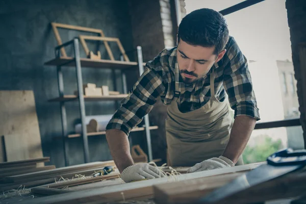 Low below angle view photo of serious confident thoughtful concentrated man focused on polishing frame of wood with emery paper — Stock Photo, Image