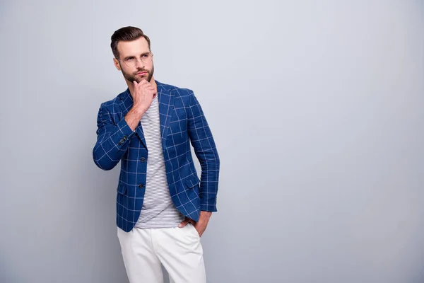 Photo of well looking serious smart man with hands in white trousers pocket touching bearded chin contemplating empty space isolated grey color background — Stock Photo, Image