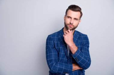 Photo of focused interested man looking into empty space in checkered blazed touching his bearded chin isolated grey color background clipart