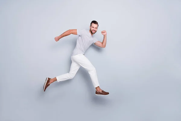 Full length body size view of his he nice attractive sporerful cheerful cheery purposeful strong bearded guy running fast discount isolated over light grey pastel color background — стоковое фото
