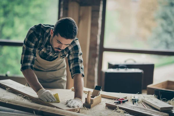 Portrait of his he nice attractive skilled hardworking professional guy self-employed builder carving wood on table desk making cabinetry at modern industrial loft brick style interior indoors — Stock Photo, Image
