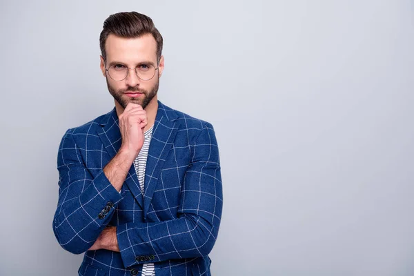 Photo of serious interested man touching bristle chin looking intently at you wearing spectacles near empty space isolated grey color background