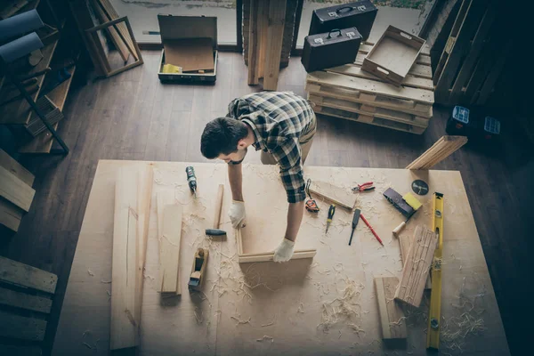 Foto von nachdenklichen Handwerker, der Rahmen mit Holzblöcken mit Instrumenten umgeben — Stockfoto