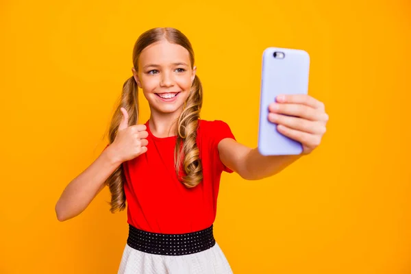 Bien joué. Photo de jolie petite dame tenant téléphone faisant selfies levant pouce doigt vers le haut pour blog porter casual robe rouge blanc isolé couleur jaune vif arrière-plan — Photo