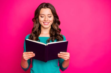 Photo of cheerful positive nice cute charming girlfriend looking thorugh her copybook in search of answers to questions she has smiling toothily isolated fuchsia color vivid background clipart