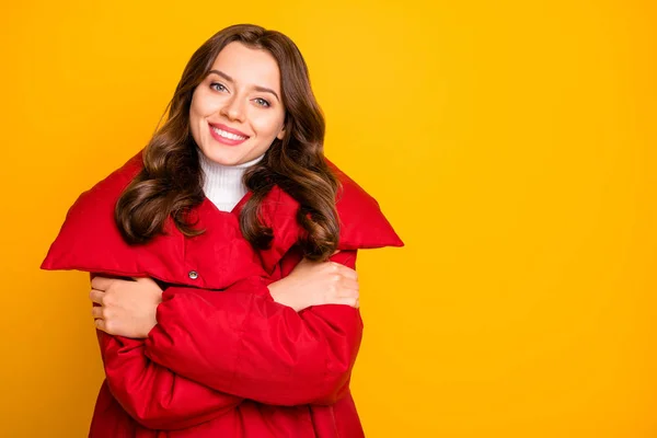 Photo of charming pretty lady enjoy warm weather hugging shoulders overjoyed wear red warm winter outerwear overcoat isolated yellow color background — Stock Photo, Image