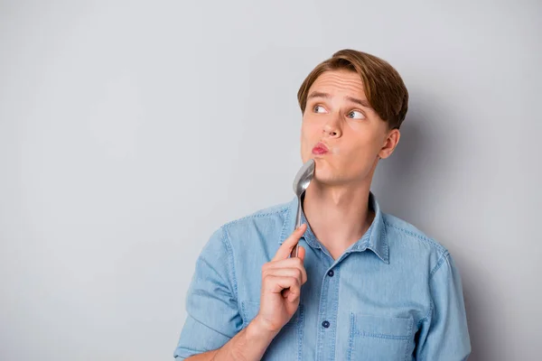 Portrait of minded pensive guy visit modern cuisine restaurant think thoughts copyspace doubt can offer yummy meal put silver spoon chin wear stylish clothes isolated grey color background — Stock Photo, Image