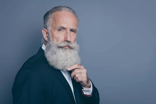 Close-up profile side view portrait of his he nice attractive suspicious well-groomed gray-haired man macho model thinking touching beard isolated over grey violet purple pastel color background — Stock Photo, Image