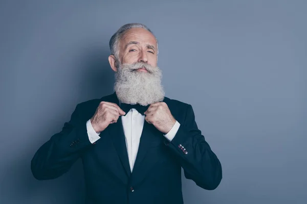 Close-up portrait of his he nice attractive content proud arrogant gray-haired man wearing tux fixing bowtie preparing for event isolated over grey violet purple pastel color background — Stock Photo, Image