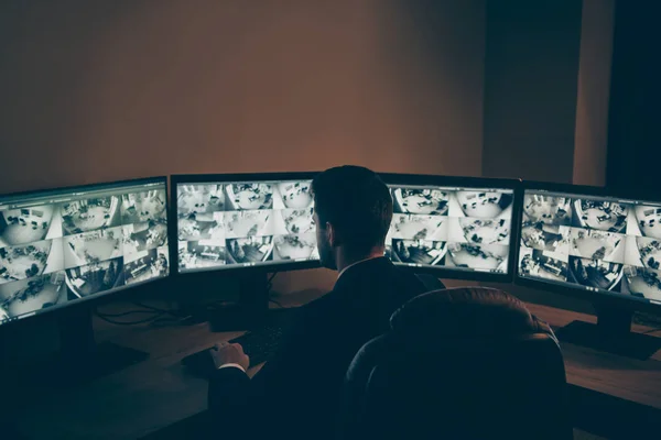 Rear back behind view of his he qualified experienced skilled man supervising remote panel using modern technology equipment night shift support standard at workplace workstation — Stock Photo, Image