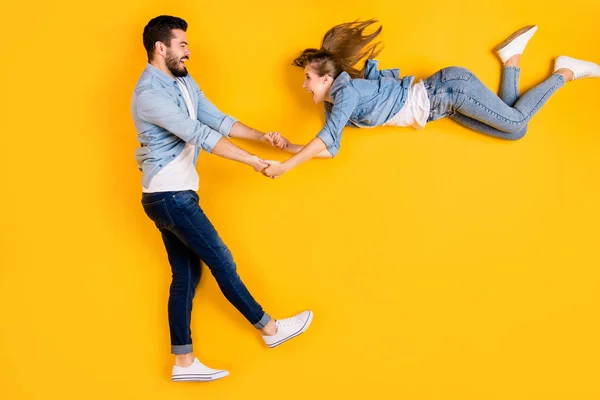 Top view above high angle flat lay flatlay lie full length body size view concept of cheerful cheery beautiful handsome spouse having fun isolated on bright vivid shine vibrant yellow color background — 스톡 사진