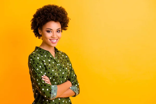 Turned photo of optimistic millennial afro american person girl cross hands look good smile enjoy working day time wear trendy clothing isolated over yellow color background — Stock Photo, Image