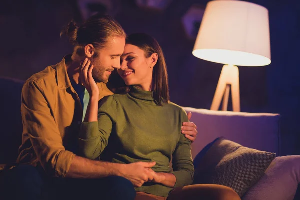 Close-up portrait of his he her she nice attractive lovely affectionate tender lovable cheerful dreamy couple girl sitting on divan spending day weekend kissing at night dark home house apartment — Stock Photo, Image