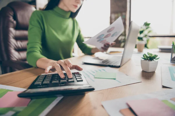 Cropped closeup photo of busy business lady notebook table hold paper stats calculating numbers sums money income sit chair wear green turtleneck modern office — Stock Photo, Image