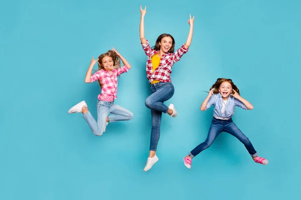 Full length body size photo of funky funny excited trendy family who are rock fans jumping joyfully wearing jeans denim white while isolated with blue background — Zdjęcie stockowe