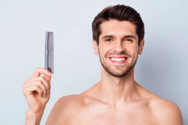 Close-up portrait of his he nice attractive cheerful cheery glad brown-haired guy holding in hand hair comb domestic salon grooming modern look isolated on light white grey color pastel background — Stock Photo, Image