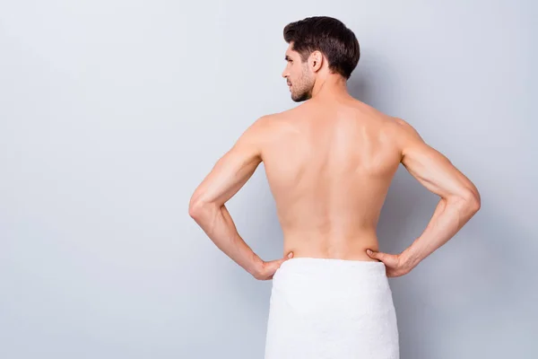 Back rear profile side photo of handsome macho man stand look copyspace after gym training gym shower feel skin smooth silky have white towel isolated over grey color background — Stockfoto