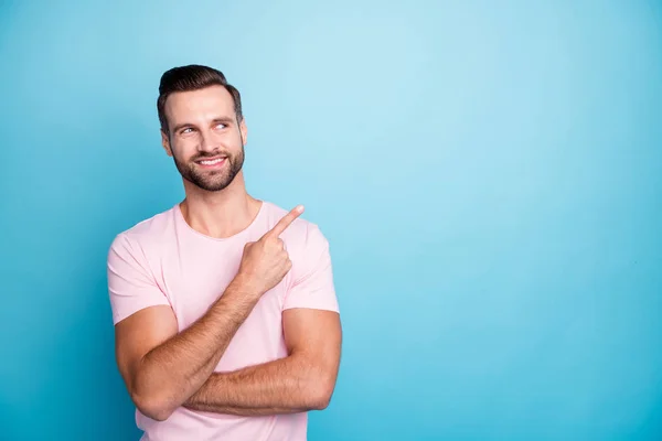 Foto de cara engraçado indicando dedo vazio espaço aconselhando legal baixos preços de desconto melhores produtos de qualidade usar casual rosa t-shirt isolado azul cor de fundo — Fotografia de Stock