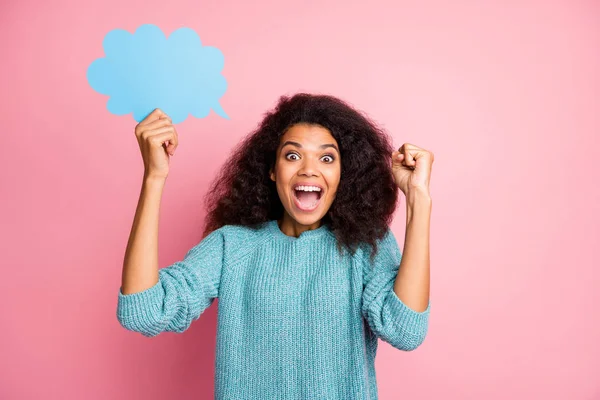 Photo of fashionable brown haired curly wavy trendy cheerful casual woman holding bubble with copyspace expressing emotions on face isolated in blue jumper pastel pink color background — Stock Photo, Image