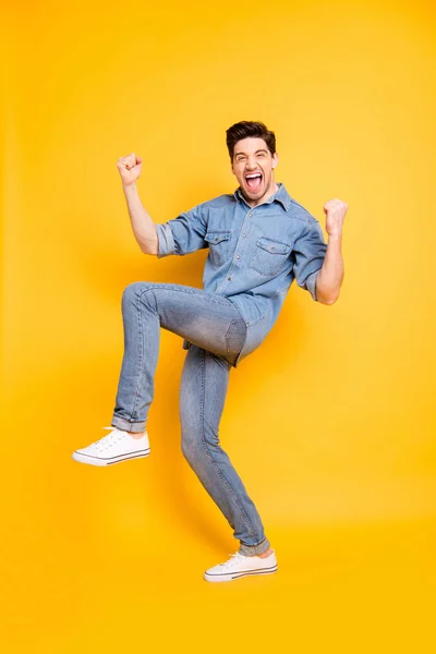 Vertical full length body size view of his he nice attractive crazy cheerful cheery funky guy celebrating good news isolated over bright vivid shine vibrant yellow color background