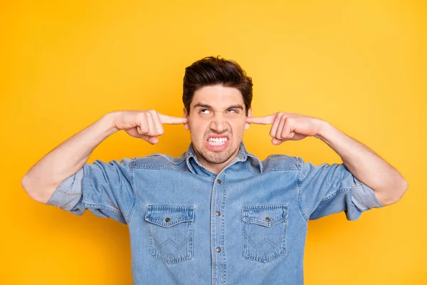 Photo of crazy mad man insane about his upper neighbours making noise at night shutting his ears isolated bright color background