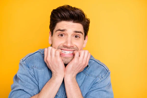 Close-up portrait of his he nice attractive handsome funky guy biting nails horrified horrible news isolated over bright vivid shine vibrant yellow color background — 스톡 사진