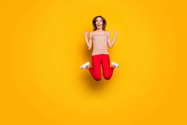 Full body photo of crazy funky amazed girl hear wonderful news about black Friday discounts jump scream wow omg wear good looking clothes white sneakers isolated over shine color background — Stockfoto