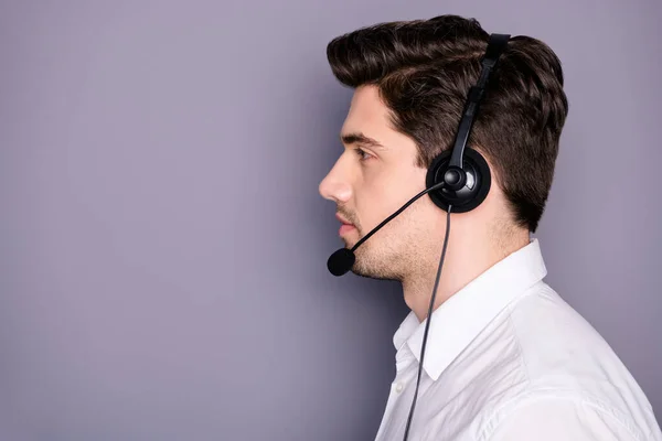 Profile side photo of serious sure cool customer support worker look copyspace have earphones help clients wear formal white shirt isolated over grey color background — Zdjęcie stockowe