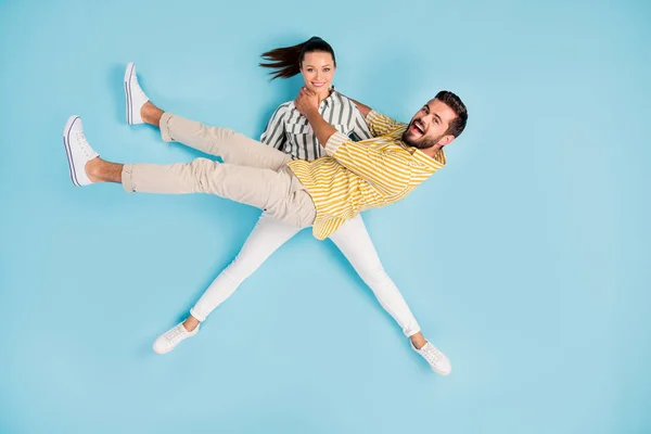 Visão superior acima de alto ângulo flat lay flatlay lie concept full length body size view of nice crazy girl carrying guy having fun isolated on bright vivid shine vibrant blue turquesa color background — Fotografia de Stock