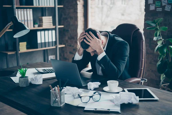 Photo of helpless business guy crumple papers holding head hands need rest work day night workaholic tired powerless wear black blazer shirt suit sitting chair office indoors — Stock Photo, Image