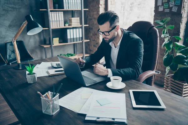 Profile photo of handsome business guy holding fists near notebook table reading awful wrong report stupid workers wear specs black blazer shirt suit sitting chair office indoors — 스톡 사진