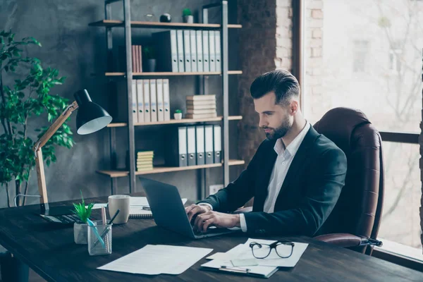 Profile photo of attentive business brunet guy looking notebook table communicating colleagues reading email letters wear blazer shirt suit sitting chair office indoors — 스톡 사진