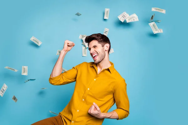 Photo of excited ecstatic crazy shouting manager having received salary payment wearing yellow shirt saying yes isolated over pastel color blue background — Stock Photo, Image