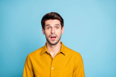 Photo of shocked amazed handsome attractive guy in formalwear learning new shocking information in yellow shirt isolated over blue pastel color background clipart