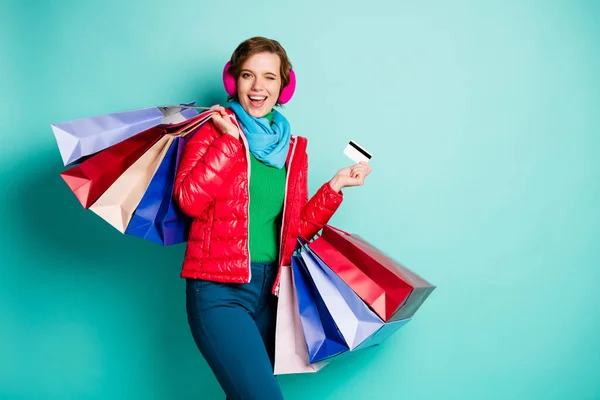 Girl shopping center client hipster funky student hold bags pay debit card wink blink recommend bargain wear outerwear green jumper pink blue pants trousers isolated teal color background — ストック写真