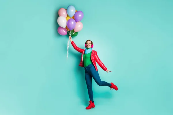 Full size photo of cheerful lovely girl hold many air helium balls flying in sky wear pink stylish autumn green jumper look boots isolated over turquoise color background — 스톡 사진