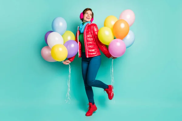 Full body photo of amazing youngster lady birthday party bring colorful air balloons wear casual red coat scarf pink ear muffs pants shoes outfit isolated teal color background — Stock Photo, Image