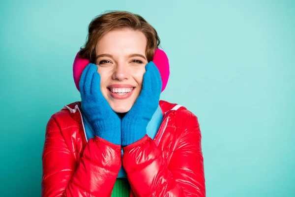 Closeup photo of funny lady holding hands on cheekbones excited christmas holiday emotions wear casual red overcoat gloves scarf pink ear covers isolated teal color background — Stock Photo, Image