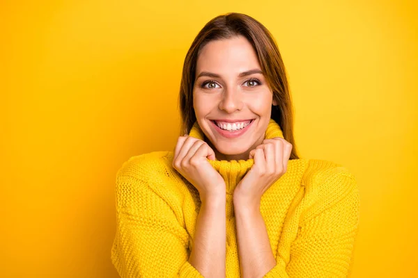 Close-up foto van positieve vrolijke meisje tevreden voelen in de winter vakantie weekend aanraken haar warme zachte levendige trui geïsoleerd over gele kleur achtergrond — Stockfoto