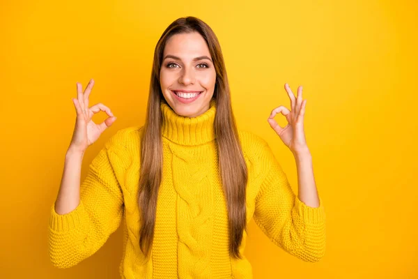 Portrait of positive cheerful girl promoter show okay sign recommend ad advertise promotion wear vivid jumper isolated over yellow color background — 스톡 사진