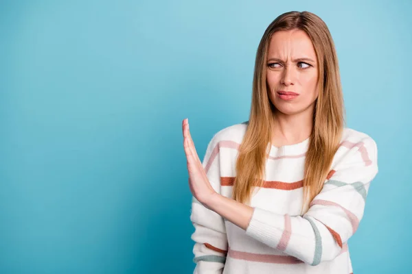 Photo of disgusted woman restricting access to her by gesturing with hand looking into empty space with displeasure isolated pastel color background — Stock Photo, Image