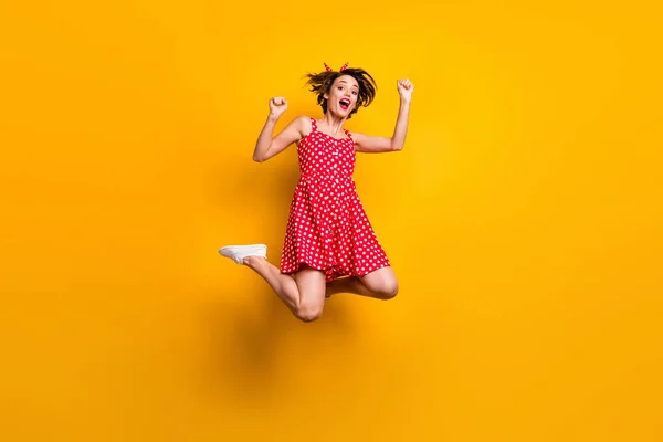 Full length photo of cheerful crazy ecstatic girl win lottery enjoy rejoice victory jump raise fists scream yes wear good look skirt sneakers isolated over bright color background — Stock Photo, Image