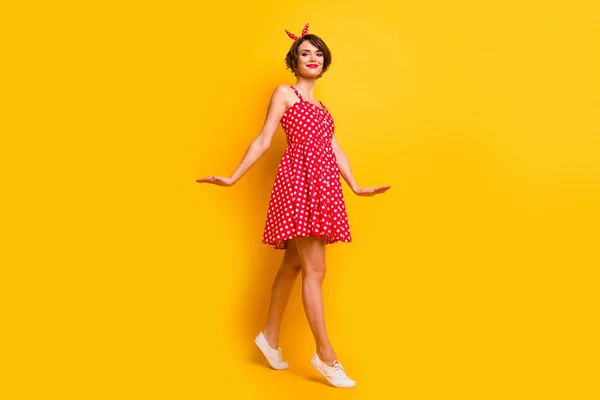 Full length photo of content pretty girl enjoy spring free time weekends go walk wear polka-dot clothes isolated over bright color background — 스톡 사진