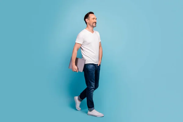 Full length body size view of his he nice attractive cheerful content mature guy walking carrying laptop isolated on bright vivid shine vibrant teal green blue turquoise color background — 스톡 사진