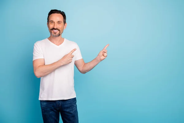 Portrait of his he nice attractive cheerful cheery guy showing copy empty blank space advert ad promotion isolated on bright vivid shine vibrant teal green blue turquoise color background — Stock Photo, Image