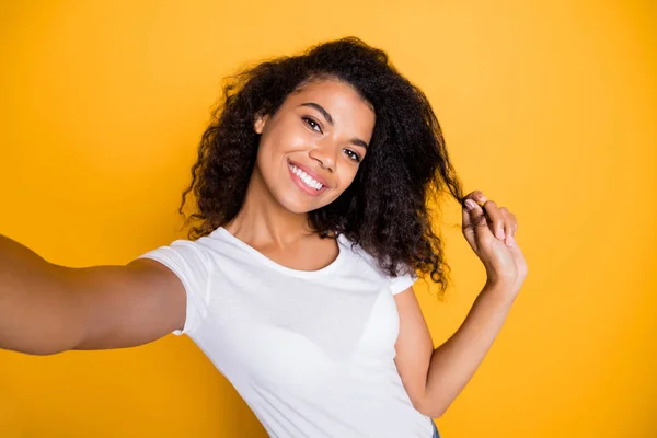 Self-portrait of her she nice attractive lovely charming cute winsome sweet cheerful cheery wavy-haired girl playing with curl flirting isolated over bright vivid shine vibrant yellow color background — 스톡 사진