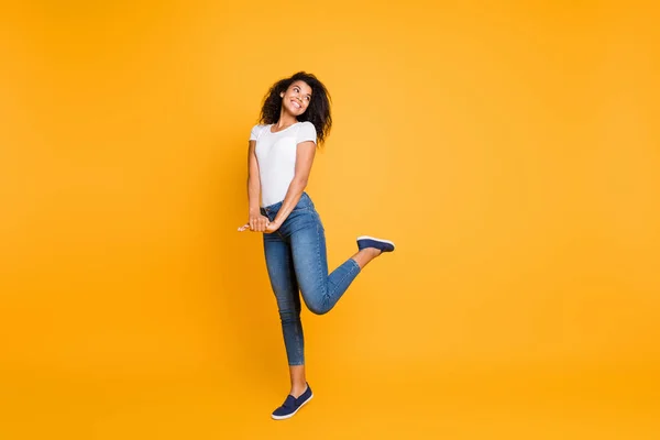 Full length body size view of her she nice attractive lovely charming cheerful cheery girlish shy wavy-haired girl posing having fun isolated over bright vivid shine vibrant yellow color background — Stock Photo, Image