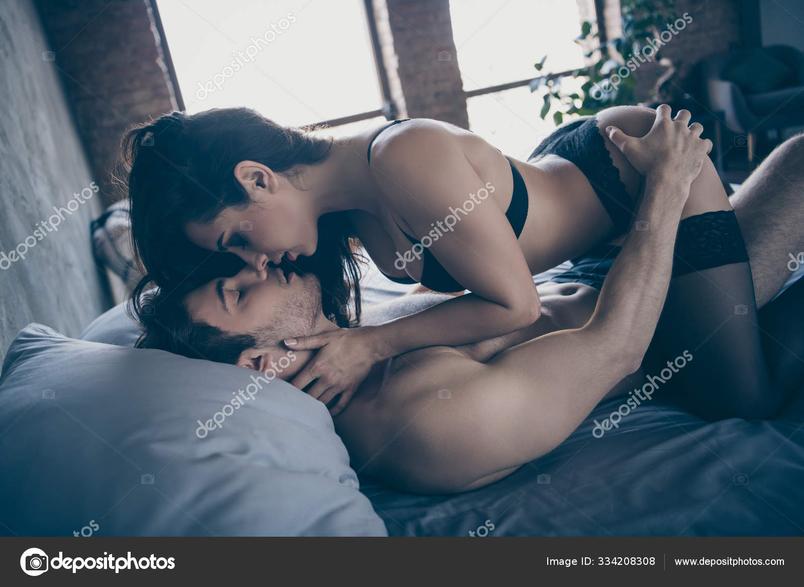 Profile photo of two tenderness partners people kissing horny macho guy lying bed hot girlfriend sitting on top wear black tights bikini having sex linen house room indoors Stock Photo by ©deagreez1 photo