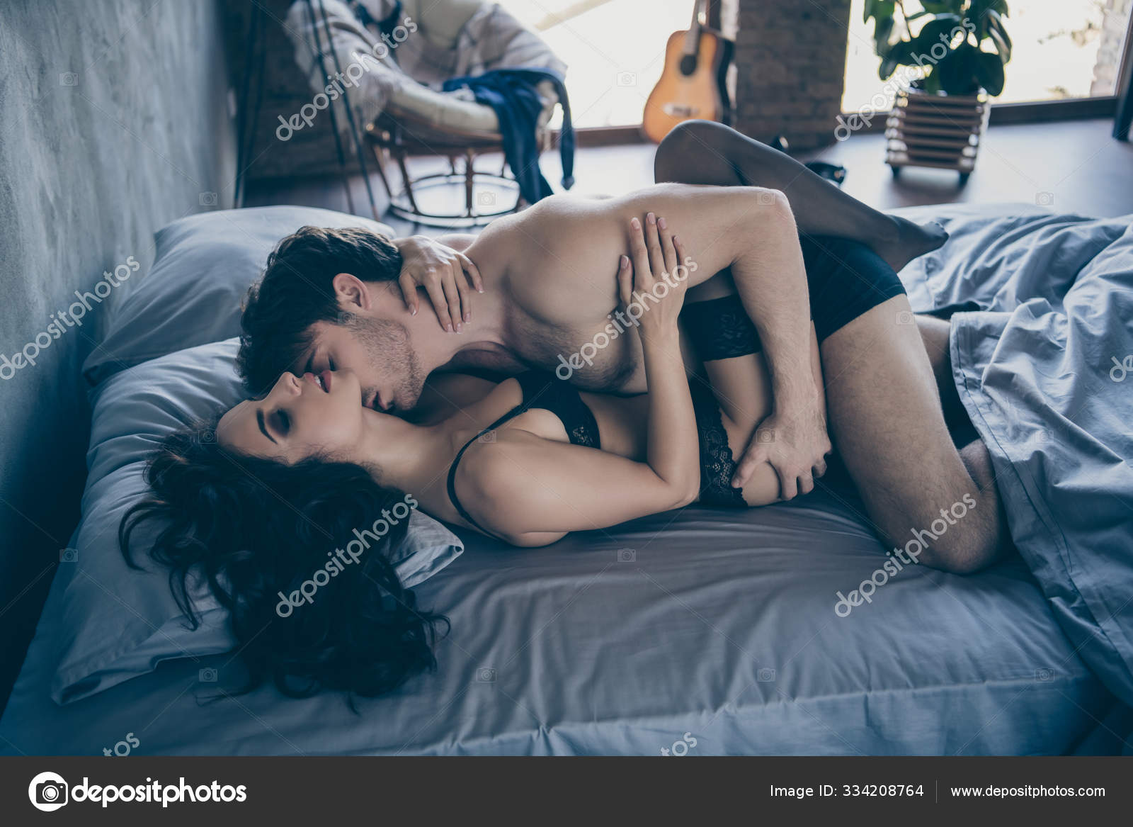 Profile photo of two seductive partners people kissing horny masculine guy lying on-top girlfriend body black pantyhose bikini having sex morning bed linen house room indoors Stock Photo by ©deagreez1 334208764 picture picture